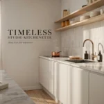 Timeless studio kitchenette with marble counters, white tile backsplash, open shelves and soft natural light