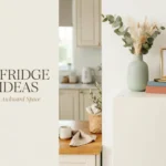 Woven baskets, cookbooks, and a vase styled on top of a refrigerator