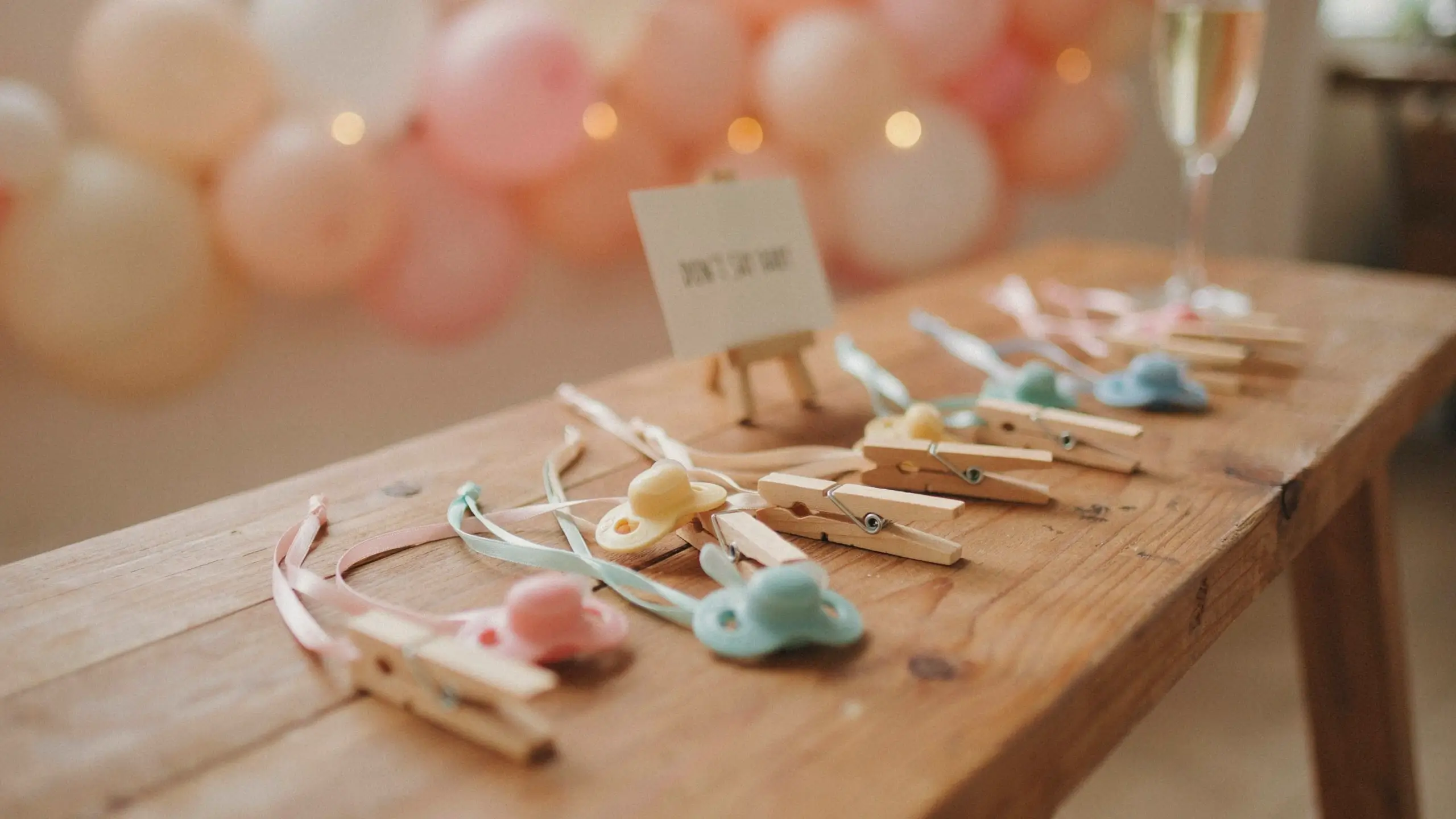 Close-up of an expecting mother gently cradling her pregnant belly with a warm welcome message overlay celebrating motherhood. 