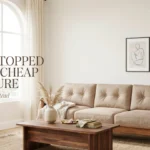 Sunlit living room with a wood-frame sofa and text reading “Why I Stopped Buying Cheap Furniture.”