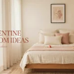 Minimalist and romantic bedroom setup with cream linen bedding, blush pink throw pillows, scattered rose petals, open book, and warm ambient lighting, overlaid with text "20 Valentine Bedroom Ideas romantic without the cheese".