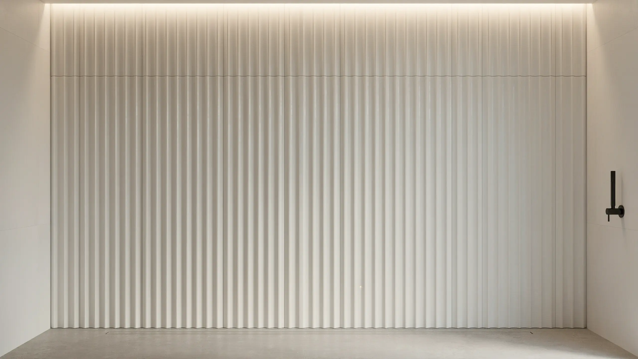 Dark charcoal slate wall tiles creating a moody and minimalist aesthetic in a modern bathroom interior.