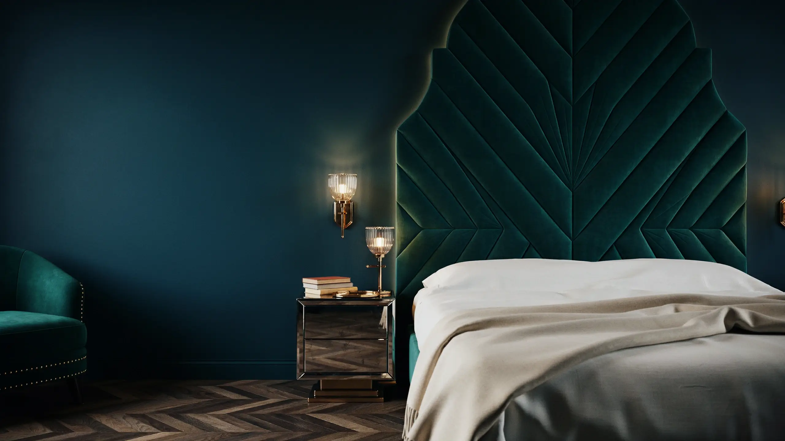 Dark teal velvet Art Deco headboard with geometric chevron design in a luxurious glam bedroom with brass sconces and mirrored nightstand.