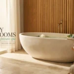 Modern luxury spa bathroom featuring a freestanding stone bathtub with a gold faucet, wooden bath tray with candle and eucalyptus, and vertical wood slat wall paneling.