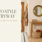 How to Style an Entryway" guide image showing a welcoming foyer with a light wood console table, round brass mirror, and woven storage baskets for a cozy, organized look.