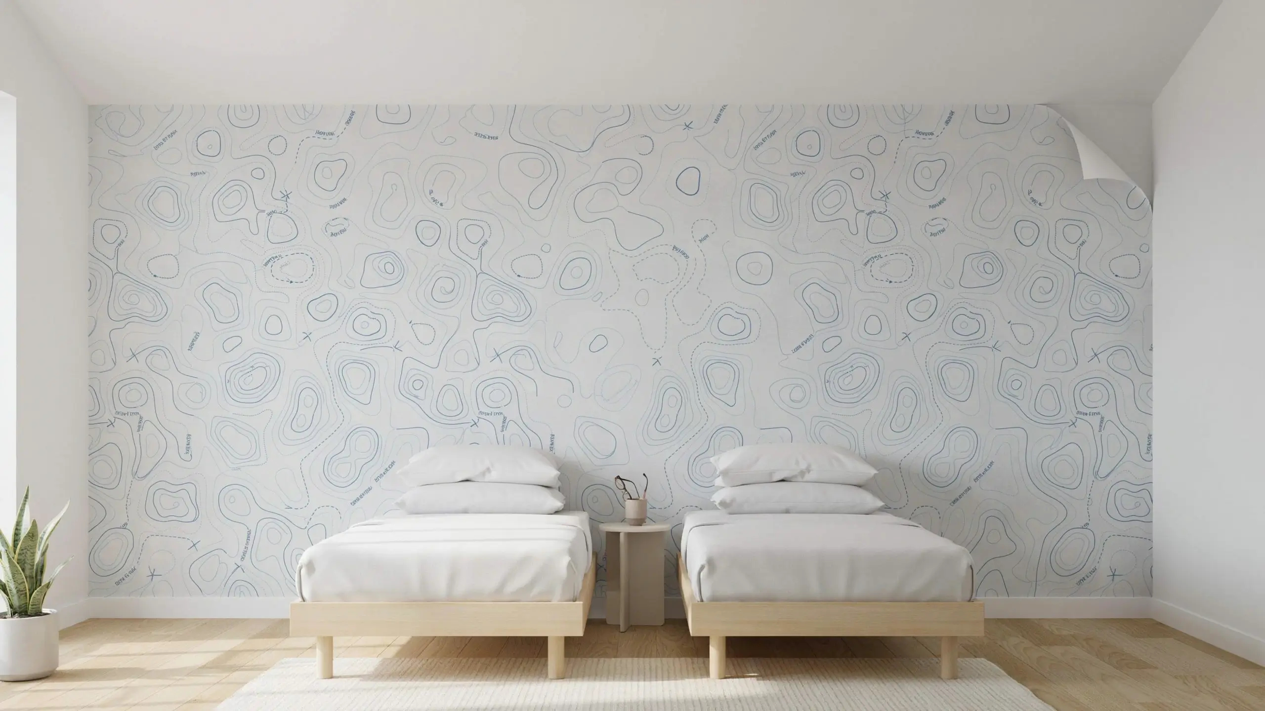 Modern twin bedroom featuring light wood beds, white bedding, and a prominent blue and white removable topographic map accent wallpaper on a minimalist white wall.