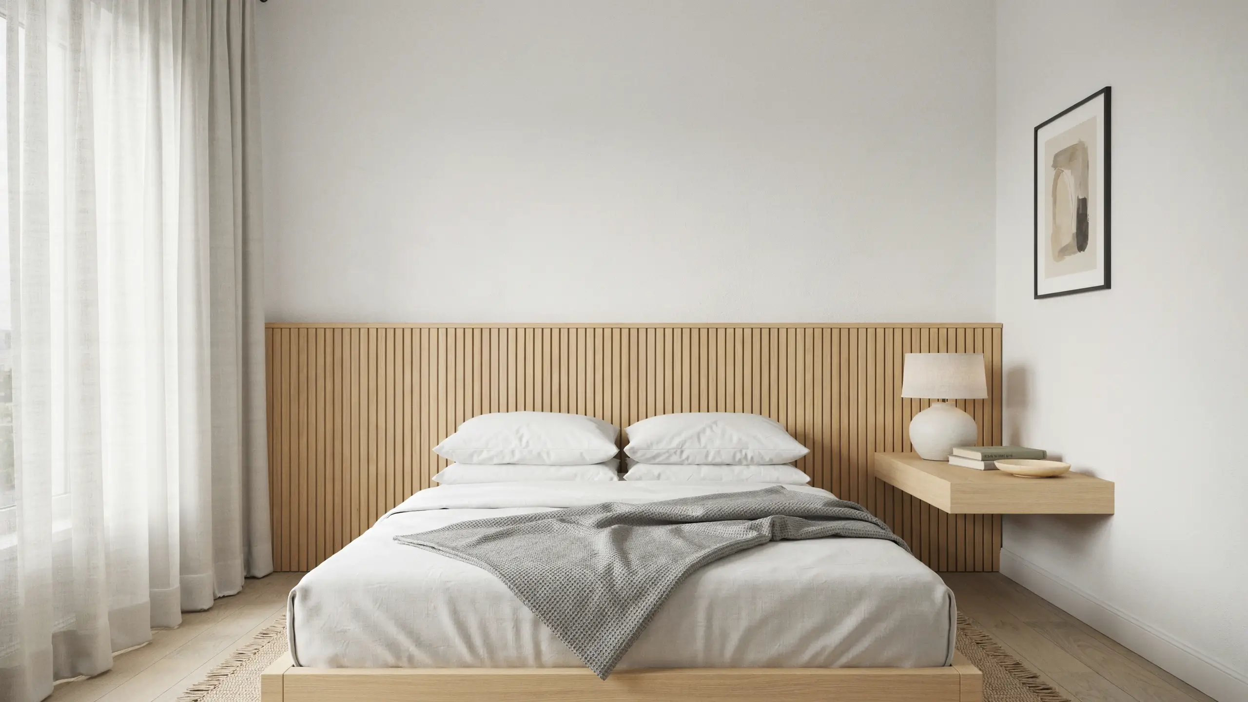 Scandinavian minimalist bedroom featuring a light wood slatted headboard, white linen bedding with a grey throw, and a floating nightstand with a white ceramic lamp.