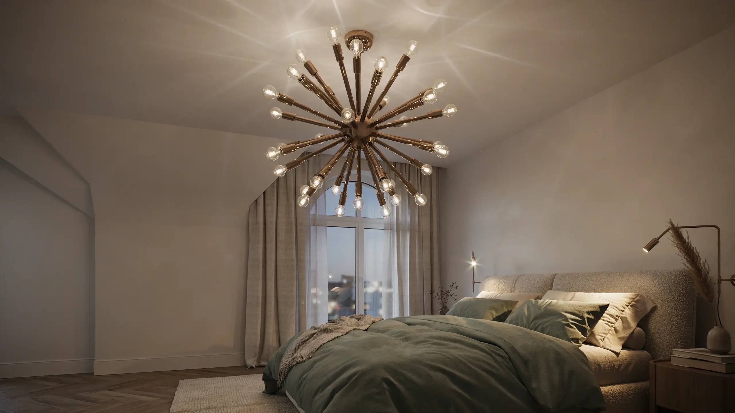 Large brass Sputnik-style chandelier with glowing exposed bulbs illuminating a modern attic bedroom with sage green bedding, a beige upholstered headboard, and a sloped white ceiling.