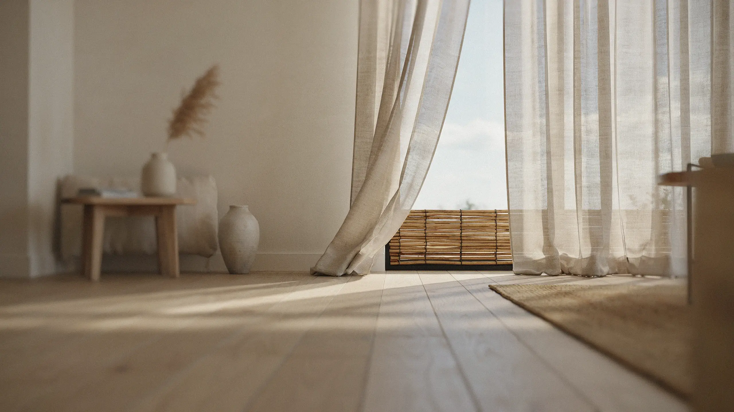 Bright airy living room featuring sheer beige linen curtains and a bamboo roller blind letting in warm natural sunlight