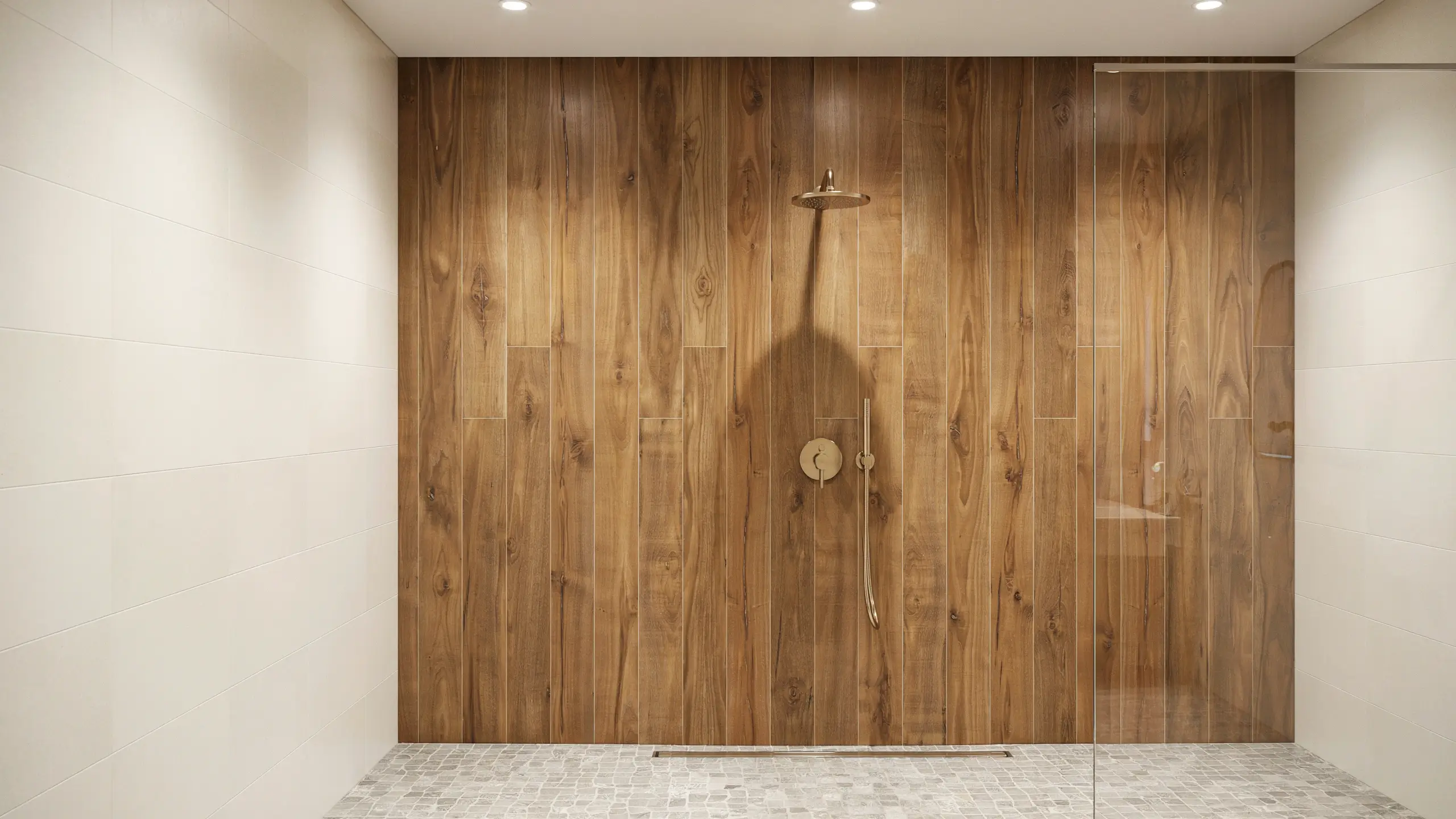 Modern walk-in shower featuring vertical wood-look porcelain tile on the back wall, paired with white large-format side tiles, a frameless glass partition, and brushed brass fixtures.